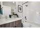 Bathroom with modern fixtures, wood vanity, shower and tub with subway tile at 1286 Raleigh St, Denver, CO 80204