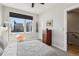 Well-lit bedroom with a mid-century modern chair, blackout shades, and neutral decor at 1286 Raleigh St, Denver, CO 80204