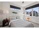 Bright bedroom with large windows, modern decor, and a comfortable bed at 1286 Raleigh St, Denver, CO 80204