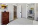 Cozy bedroom showcases modern decor, ensuite bathroom, and staircase access at 1286 Raleigh St, Denver, CO 80204