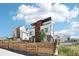 Striking modern home exterior with white siding, wood accents, and a charming fenced yard for privacy at 1286 Raleigh St, Denver, CO 80204