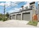 Attached three-car garage to the house with a modern look and a side yard area at 1286 Raleigh St, Denver, CO 80204