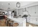 Modern kitchen boasts a large island with seating, stainless steel appliances and stylish pendant lighting at 1286 Raleigh St, Denver, CO 80204