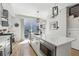 Bright kitchen with stainless steel appliances, an island with a built-in microwave, and sliding doors to the patio at 1286 Raleigh St, Denver, CO 80204