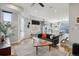 Open concept living room with hardwood floors, modern lighting, and seamless flow to kitchen at 1286 Raleigh St, Denver, CO 80204