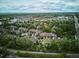 Wide aerial view of a residential area with community pool, lush trees, and well-maintained townhomes at 1441 S Ulster St, Denver, CO 80231