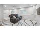 Cozy basement area features a comfortable reclining sofa and neutral decor at 1441 S Ulster St, Denver, CO 80231