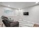 Cozy basement with comfortable seating and a wall-mounted television for entertainment at 1441 S Ulster St, Denver, CO 80231
