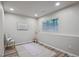Bright basement area featuring a yoga mat, chair, and window for natural light at 1441 S Ulster St, Denver, CO 80231