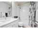 Neutral bathroom features a shower-tub combo with a white shower curtain and vanity at 1441 S Ulster St, Denver, CO 80231