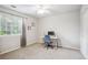 Bright bedroom with a modern desk, plush carpet, and light window at 1441 S Ulster St, Denver, CO 80231