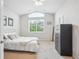 Bright bedroom features a large window, plush carpet, and high vaulted ceilings at 1441 S Ulster St, Denver, CO 80231