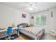Comfortable bedroom features a ceiling fan, bright window, and colorful accents at 1441 S Ulster St, Denver, CO 80231