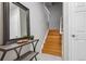 Bright entryway showcasing a wooden staircase, decorative table, and a large mirror at 1441 S Ulster St, Denver, CO 80231