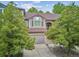 Charming home featuring gray siding, mature trees, and a two-car garage at 1441 S Ulster St, Denver, CO 80231