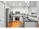 Modern kitchen featuring stainless steel appliances, white cabinets, and sleek countertops at 1441 S Ulster St, Denver, CO 80231