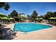 Inviting community pool with ample seating, umbrellas, and pergola, creating a resort-like atmosphere at 1441 S Ulster St, Denver, CO 80231