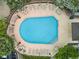 Aerial view of a community pool surrounded by lounge chairs and lush landscaping at 1441 S Ulster St, Denver, CO 80231