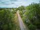 Scenic aerial view of a walking path lined with lush trees in a residential community at 1441 S Ulster St, Denver, CO 80231