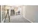 Finished basement with carpeted floors, a staircase, and a dedicated office space with modern desk and chair at 1640 Harrison St, Denver, CO 80206