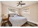 Cozy bedroom featuring a ceiling fan, warm neutral paint, and lots of natural light at 1640 Harrison St, Denver, CO 80206