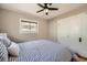 Bedroom featuring a ceiling fan, closet, and a geometric patterned comforter at 1640 Harrison St, Denver, CO 80206