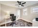 Bright bedroom features a ceiling fan, hardwood floors, and a dedicated workspace with desk and computer setup at 1640 Harrison St, Denver, CO 80206