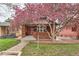 Charming red brick home with blossoming tree and inviting front yard at 1640 Harrison St, Denver, CO 80206