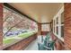 Comfortable covered front porch with seating and brick detail at 1640 Harrison St, Denver, CO 80206