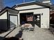 Detached garage with work area and extra storage, featuring a stylish two-tone exterior and outdoor seating at 1640 Harrison St, Denver, CO 80206