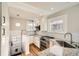 Well-lit kitchen featuring white cabinets, granite countertops, stainless steel appliances, and subway tile backsplash at 1640 Harrison St, Denver, CO 80206