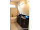 Beautiful bathroom with a soaking tub and dual vessel sinks on dark cabinetry at 15305 W 93Rd Ave, Arvada, CO 80007
