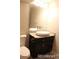 Modern bathroom with an oval mirror, stone countertop and a white vessel sink at 15305 W 93Rd Ave, Arvada, CO 80007