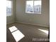 Bright bedroom with natural light, neutral carpeting, and spacious layout at 15305 W 93Rd Ave, Arvada, CO 80007