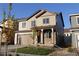 Charming two-story home with stone accents, covered porch, and a two-car garage at 15305 W 93Rd Ave, Arvada, CO 80007