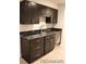 Well-designed kitchen with dark cabinets, sleek countertops, and modern fixtures at 15305 W 93Rd Ave, Arvada, CO 80007
