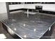 Close-up of kitchen island featuring granite countertops and dark cabinetry at 15305 W 93Rd Ave, Arvada, CO 80007