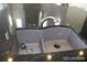 Kitchen sink features stainless steel faucet and black granite countertops at 15305 W 93Rd Ave, Arvada, CO 80007