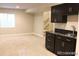 Cozy living room with kitchenette, dark cabinets and a window at 15305 W 93Rd Ave, Arvada, CO 80007