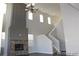 Living room boasts soaring ceilings, a stone fireplace, and a chandelier at 15305 W 93Rd Ave, Arvada, CO 80007