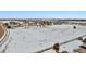 Aerial view of an extensive snow-covered lot with neighboring homes and trees in the background at 6985 Fallon Cir, Castle Rock, CO 80104