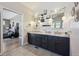 Elegant bathroom features dual sinks, granite countertops, and custom cabinetry with a view to the bedroom at 6985 Fallon Cir, Castle Rock, CO 80104