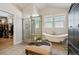 Bright bathroom featuring a freestanding tub, large walk-in shower and natural light at 6985 Fallon Cir, Castle Rock, CO 80104