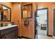 Bathroom featuring a dark wood vanity and a view into the bedroom at 6985 Fallon Cir, Castle Rock, CO 80104