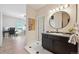 Bathroom with black cabinets, undermount sink and view into bedroom and office space at 6985 Fallon Cir, Castle Rock, CO 80104