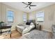 Bright bedroom features three windows, modern ceiling fan, and neutral walls at 6985 Fallon Cir, Castle Rock, CO 80104
