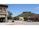 View of downtown Castle Rock with local businesses, street parking, and the iconic Rock in the background at 6985 Fallon Cir, Castle Rock, CO 80104
