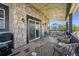 Charming deck with stone siding, outdoor seating and string lights at 6985 Fallon Cir, Castle Rock, CO 80104