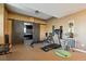 Home gym featuring treadmill, rowing machine, stationary bicycle, and barn doors at 6985 Fallon Cir, Castle Rock, CO 80104