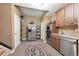 Additional kitchen area features stainless steel appliances, adjacent to the staircase at 6985 Fallon Cir, Castle Rock, CO 80104